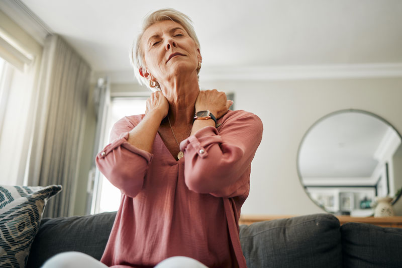 Senior woman experiencing neck pain from fibromyalgia